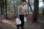 Strider struggled as he carried gallons of water filled from a spigot to the camper. Lanette would heat the water on a small stove to do the dishes and bathe the boys with a washcloth.