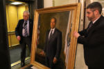 At the conclusion of a State House reception for supporters of outgoing Governor Deval Patrick, his unveiled portrait is wheeled down a hallway and to an elevator, for hanging in the Governor's office lobby.