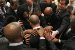 At the end of his last monthly meeting with area religious leaders at Roxbury Presbyterian Church, hands are laid on Patrick in prayer.