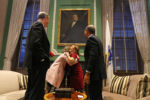 After the exchange of the traditional symbols (on the table), Governor-elect Charlie Baker, left, and outgoing Governor Deval Patrick watch as their wives, Lauren Baker, left, and Diane Patrick embrace.