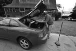Fuller Brush man Allan Cohen gets a sweeper and bags from his car before making more cold calls.