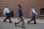 U.S. Republican presidential candidate and Ohio Governor John Kasich (L) and members of his campaign team walk to get lunch at Biederman's Deli in Plymouth, New Hampshire October 14, 2015.