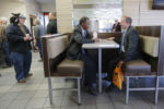 U.S. Republican presidential candidate Dr. Ben Carson (C) waits for his order at a Burger King restaurant in Concord, New Hampshire November 20, 2015.