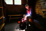 Bretton Woods, NH-09/07/15 -Ninety year-old Richard Dreselly from Topsham, Maine is the oldest man to climb Mt. Washington. He prepares his backpack at 8 a.m. holding a flashlight in his mouth as he sits on his bed at the Mizpah Spring Hut.