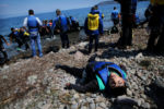 An exhausted Afghani refugee, Rahman Azimi, collapses on the shore of Lesbos. Afghanistan is so chaotic and poor that the life expectancy is less than 50 years. The refugees still have to walk 30 miles to their next destination, Mytilene, where they hope to take a ferry to Athens. On Lesbos, 2,000 refugees arrive daily along the northeastern coast, according to the International Rescue Committee.