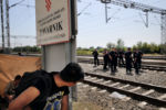 A young man watches police at the train station in Tovarnik, Croatia. Barred from Hungary, chased from Serbia, and unable to move on, refugees and migrants found themselves trapped in Croatia with few options.