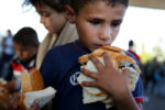 A young boy gathered as much bread as he could hold at an aid station before crossing the Austrian border outside of Hegyeshalom, Hungary. The migrants found a warm welcome from the Red Cross and a group of volunteers from Hungary, Austria and Germany.
The United Nations estimates that more than half of the 4 million Syrian refugees worldwide are women and children.