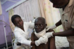 Physician's assistant, Carol Apondi, and her colleague attend to Samwell Mosota Omaiyo, a cancer patient, at the Texas Cancer Center in patient facility in Nairobi, Kenya on Monday, Aug. 24, 2015. Nurses here are trained in palliative care and give round the clock care to over a dozen patients in this small medical building.