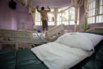 A man cleans a patient's room following his discharge from the Texas Cancer Center in patient facility in Nairobi, Kenya on Tuesday, Aug. 25, 2015. Nurses here are trained in palliative care and give round the clock care to over a dozen patients in this small medical building.