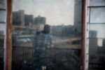 8/11/15 – Johannesburg, South Africa – Moth building residents hang out on the second floor balcony in Joubert Park on Tuesday, Aug. 11, 2015. The residents here were evicted from their previous building in New Town to make way for a new mall under construction.