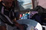 8/13/15 – Johannesburg, South Africa – Women do laundry together on the balcony of the Moth building in Joubert Park on Thursday, Aug. 13, 2015. The residents here were evicted from their previous building in New Town to make way for a new mall under construction.