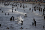 In early August, vacationers flock to the water at Old Orchard Beach.