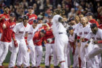 BOSTON, MA - SEPTEMBER 15: Hanley Ramirez #13 of the Boston Red Sox is mobbed by teammates after hitting a walk off three run home run during the ninth inning of a game against the New York Yankees on September 15, 2016 at Fenway Park in Boston, Massachusetts.