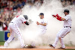 "David Ortiz #34 of the Boston Red Sox reacts as he is mobbed by Joe Kelly #18 and Travis Shaw #47 after hitting a game winning walk-off single during the eleventh inning of a game against the Houston Astros on May 14, 2016 at Fenway Park in Boston, Massachusetts."