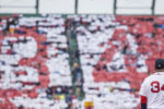 BOSTON, MA - OCTOBER 2: David Ortiz #34 of the Boston Red Sox looks on as fans hold up cards to form a number 34 in the outfield bleachers during an honorary retirement ceremony in his final regular season game at Fenway Park against the Toronto Blue Jays on October 2, 2016 at Fenway Park in Boston, Massachusetts.