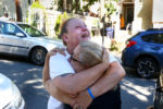The boy's mother, Melissa Willis, was embraced by a neighbor and family friend Aleida Nunez outside her home in Dorchester the day after the drowning.
