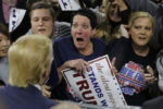 Audience member Robin Roy (C) reacts as Republican presidential candidate Donald Trump greets her at a campaign rally in Lowell, Massachusetts January 4, 2016.