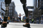 Celeste Corcoran, who lost both of her legs in the Boston Marathon bombings, greets runners at they finish the120th running of the Boston Marathon in Boston, Massachusetts April 18, 2016.
