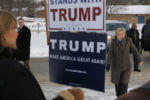 A supporter of U.S. Republican presidential candidate Donald Trump holds a sign as U.S. Democratic presidential candidate Hillary Clinton arrives outside a polling place in Nashua, New Hampshire February 9, 2016, the day of New Hampshire's first-in-the-nation primary.