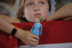Nine year-old Belle Shefrin holds a doll of U.S. Democratic presidential nominee Hillary Clinton while listening to Clinton speak at a campaign rally in Akron, Ohio October 3, 2016.