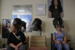 Eighteen year-old Precious Perez, who has been blind since birth, gets her hair cut and straightened, with her mother Jennifer at her side, in preparation for Precious' prom in Chelsea, Massachusetts May 19, 2016.