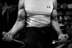 Norm Devio does curls with an arm bar as part of his workout routine in his basement in Hopkinton, Mass on April 11, 2016.