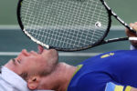 Illya Marchenko, of Ukraine, licks his racquet after losing the match in a tie-breaker against Andreas Seppi, of Italy, during the Summer Olympics in Rio de Janeiro.