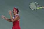 Monica Puig, of Puerto Rico, tosses her racquet and celebrates after winning the gold medal against Angelique Kerber, of Germany, during the Summer Olympics in Rio de Janeiro.