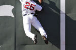 Boston Red Sox center fielder Jackie Bradley Jr. collides with the wall as he stretches but fails to make the catch on an RBI double by Tampa Bay Rays' Steven Souza Jr. in Boston.