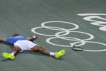 Gold Medal winner Juan Martin del Potro, of Argentina, drops to the court as he celebrates his victory over Rafael Nadal at the Summer Olympics in Rio de Janeiro.