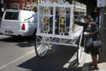 Van Nessa Jemmott places her hand on the casket as she says goodbye to her godson, Raekwon Jaquay Brown. The 17-year-old was fatally shot outside the Jeremiah E. Burke High School.