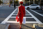 A woman stepped out onto the crosswalk as the light changed to match her outfit on Huntington Ave in Boston, MA, October 11, 2016.