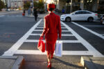 A woman stepped out onto the crosswalk as the light changed to match her outfit on Huntington Ave in Boston, MA, October 11, 2016.