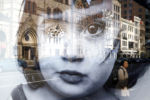 A woman pausing on Boylston Street is seen in the reflection of an advertisement on a bus stop in Boston, MA March 13, 2016.