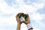 Gillian Wyman of Root 5 Farm in Fairlee, Vermont held aloft their team's mascot, "Broc".