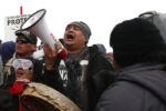 On Thanksgiving day protesters gathered across from Turtle Island, the site of a burial ground for some members of the Standing Rock Sioux and sang and prayed.