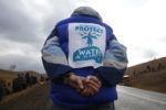 A man bowed his head in a quiet vigil along Highway 1806 during an ongoing dispute over the building of the Dakota Access Pipeline.