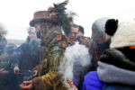 Protesters are smudged with sage before crossing the bridge to Turtle Island to protest.