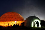 People cast silhouettes against the side of a dome inside the Oceti Sakowin camp.
