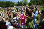 The culmination of the yearly gathering takes place at noon on the Fourth of July as thousands gather to break their silent meditation, raising their hands to let out a collective “Om” and sending up a prayer for peace.