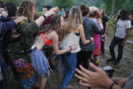 People dance and sing at a drum circle following dinner. While the group’s origin is a bit cloudy, it’s generally accepted that the first “official’’ gathering of the Rainbow Family was in Colorado in 1972.
