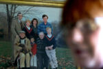 A family photo hangs in Straus's office at home. She is seen (top right) in the photo standing next to her former wife Brooke. Her parents are with her three sons and her brother.