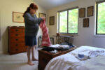 Straus picks out clothes to wear in her bedroom.