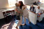 Straus (rt)from Brewster kisses Carol Wall a parishioner at The First Parish of Brewster where Straus in a member of the choir. Straus came to the church early tp prepare for the 9 a.m. church service.