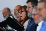 Straus (center) sings during the Sunday morning church service at The First Parish of Brewster where Straus in a member of the choir.