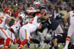New England Patriots quarterback Tom Brady (12) leaps over the middle for a one-yard touchdown in the second quarter of the AFC Divisional Playoff game against the Kansas City Chiefs in Foxborough, Massachusetts on January 16, 2016.