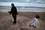 A child runs from Ed Sobel who was dressed as a gorilla, before taking part in the Marshfield Lodge of Elks annual ÒPolar Plunge" at Rexhame Beach on New Years Day. Sobel said he and a friend were both celebrating their birthday by checking the plunge off their "bucket list."