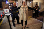 Melissa Sousa, of Braintree laughs during a security check by Steve Carbalho before entering a Blue Man Group performance at the Charles Playhouse. Sousa was celebrating with Michelle Brewer (right), who just turned 40.