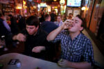 Jacob Riedel has a shot of tequila while drinking with friends at The Tam.
