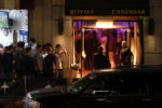 Young men and women wait to enter the Royale and Candibar nightclubs.